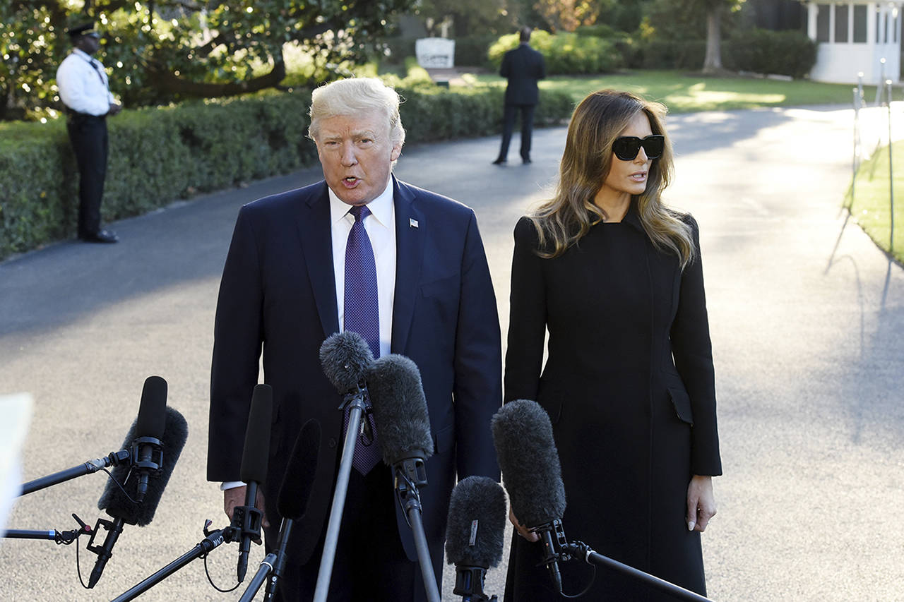 Olivier Douliery | Abaca Press                                 President Donald Trump, with First Lady Melania Trump, answers questions from the press as they depart the White House for Joint Base Andrews, en route to Las Vegas, on Wednesday.