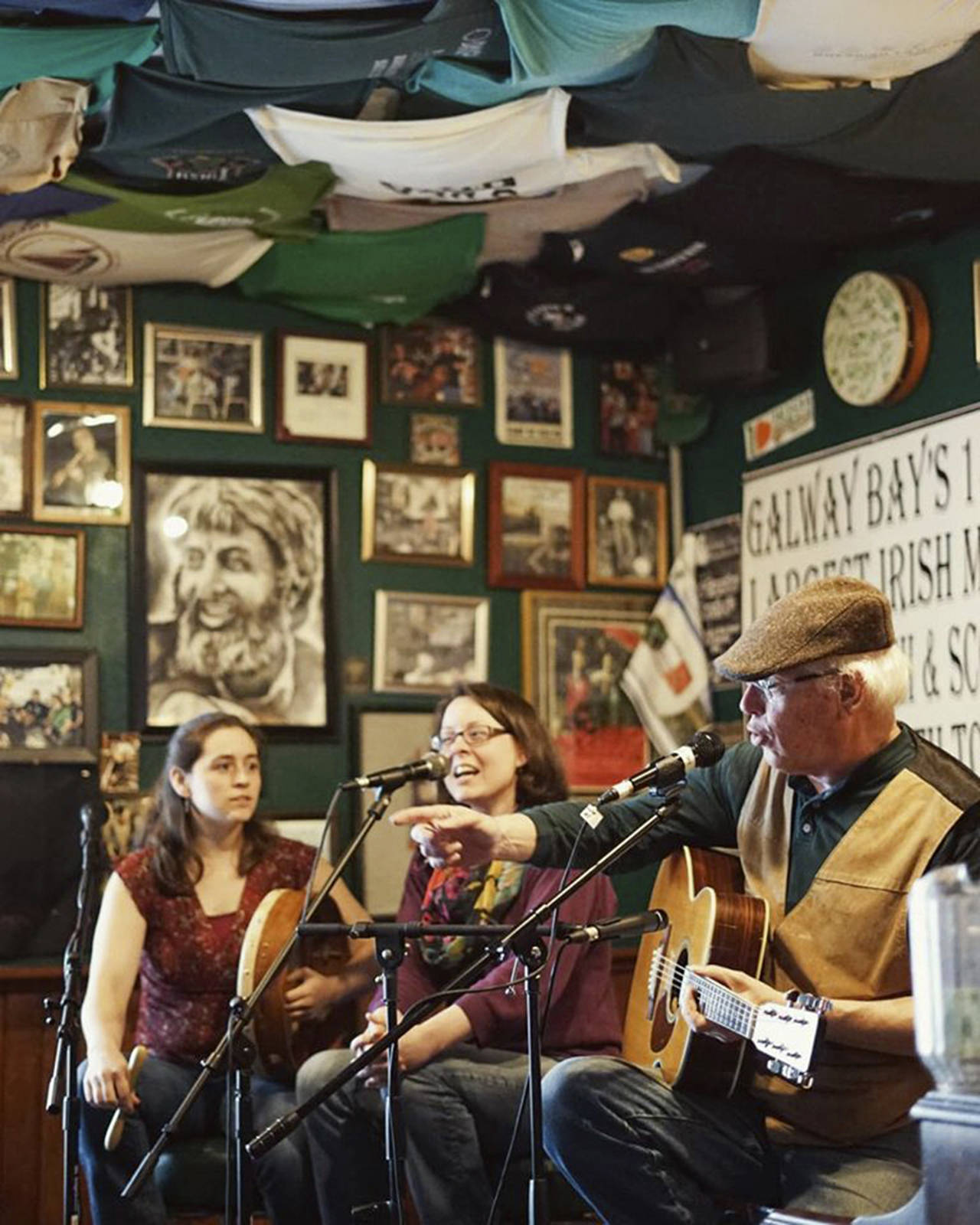 Courtesy photo                                Hank Cramer performs at Galway Bay recently with two sisters from Chehalis: Maggie MacInnis and Jessie Erickson.