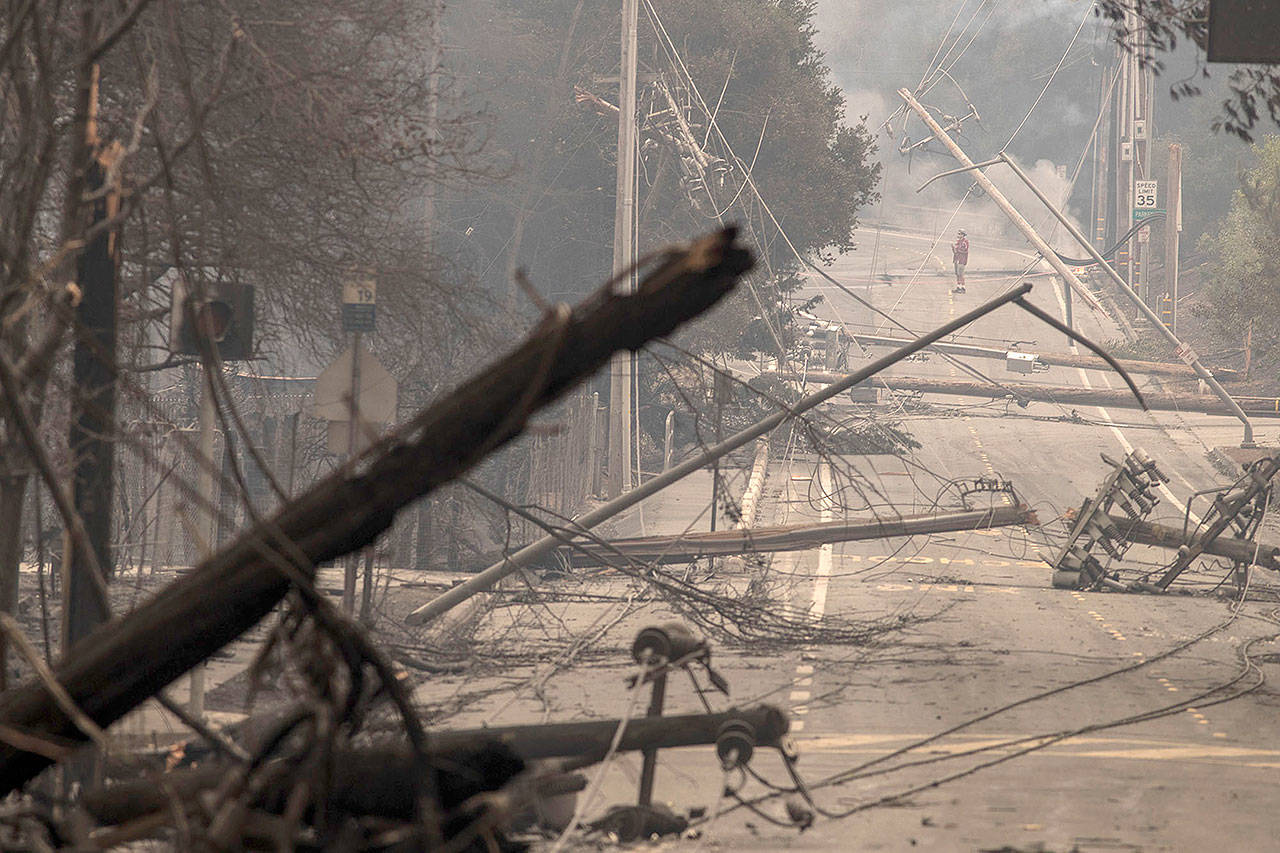Power poles and lines block a street at Brookdale and Aaron Drive in Hidden Valley, where most of the homes were destroyed by fire, on October 9, 2017, in Santa Rosa, Calif. (Brian van der Brug/Los Angeles Times)