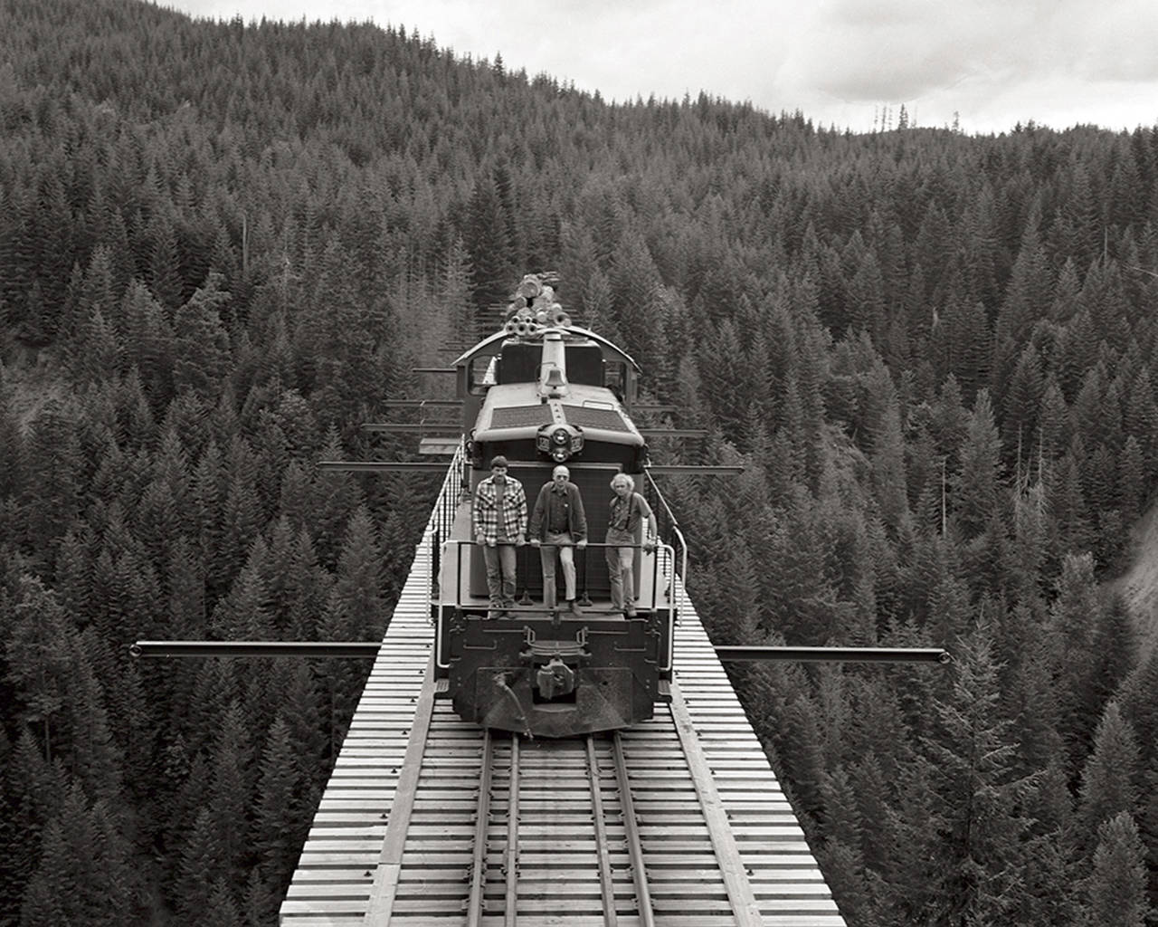 Photo by John Tylczak | Courtesy Polson Museum                                John Tylczak took this photo in 1985 from the top of a caboose on the Simpson Logging Co.’s Vance Creek railroad bridge. From left are Simpson railroad crew members Todd Young, Pete Replinger and Ed Nelson. This is one of the photos by Tylczak on display at the Polson Museum through the end of this year.