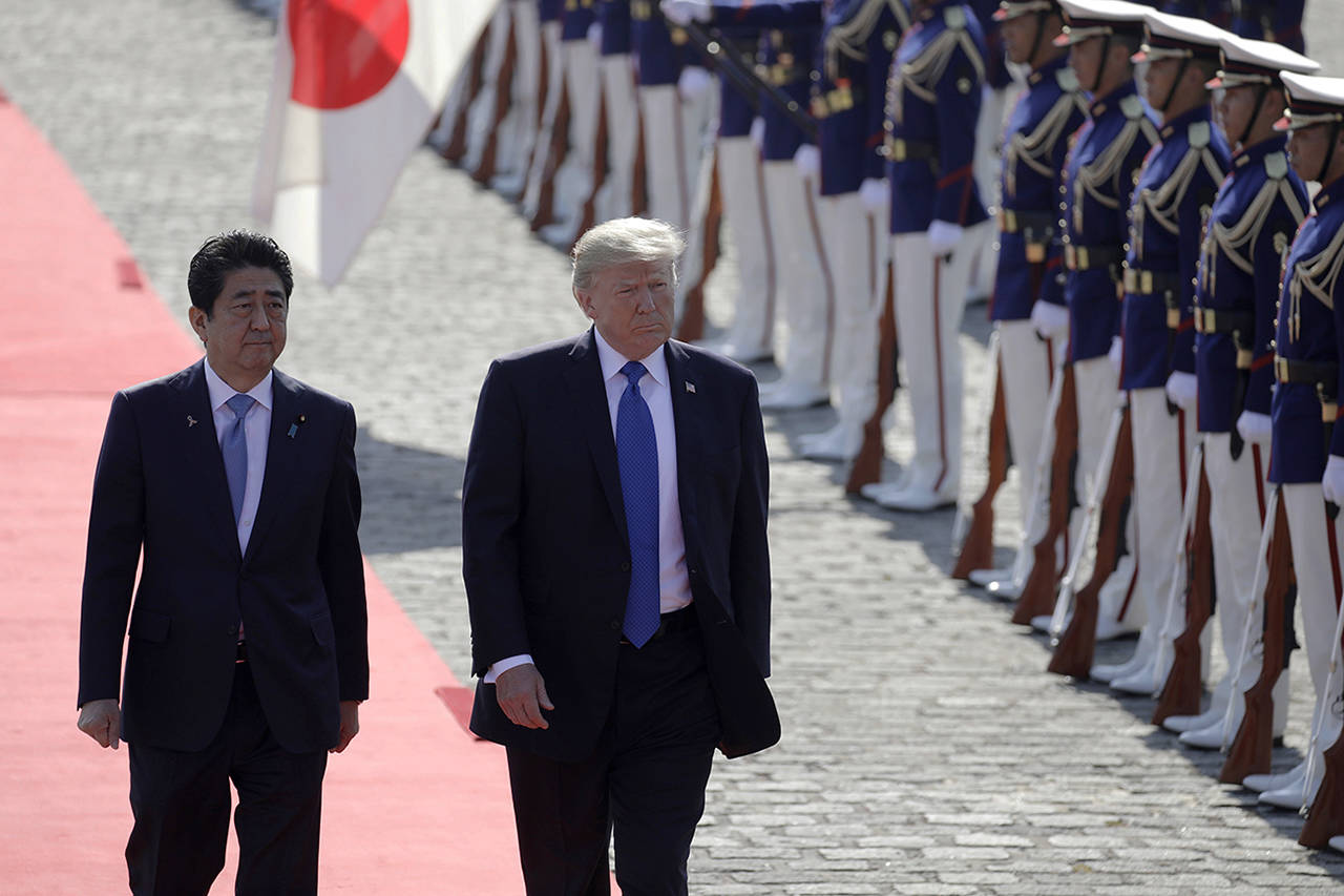 Kiyoshi Ota | Bloomberg                                 Japanese Prime Minister Shinzo Abe and President Donald Trump walk past an honor guard at Akasaka Palace in Tokyo on Monday.