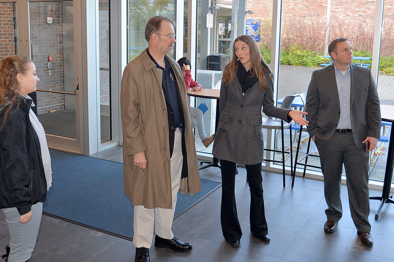 While visiting his alma mater Grays Harbor College, U.S. Ambassador Allan Mustard listens to Lisa J. Smith, the Director of College Development, explain recent developments at John Spellman Library. (Photo by Louis Krauss)