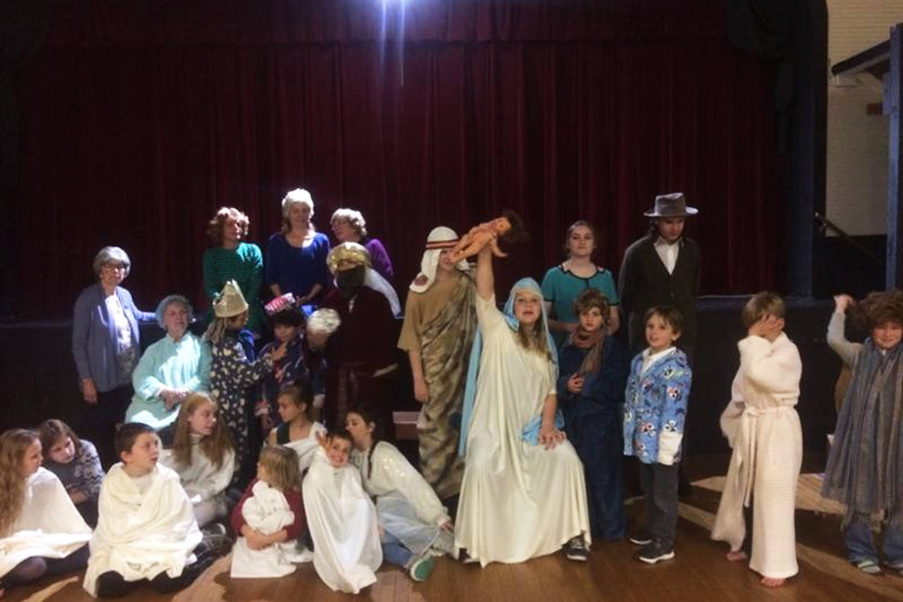 Courtesy photo                                 Cora Dooley, who plays one of the rowdy Herdman children in the Grayland Players’ production of “The Best Christmas Pageant Ever,” holds up the baby Jesus in triumph.