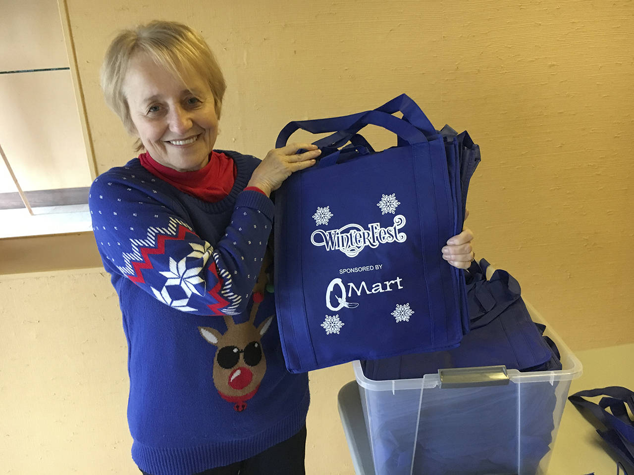 The first 200 visitors to the Winterfest Market on Friday will receive a free commemorative shopping bag, shown by event co-organizer Bobbi McCracken. (Kat Bryant | The Daily World)