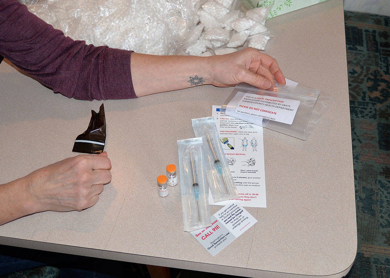 LOUIS KRAUSS | THE DAILY WORLD A staff worker at the needle exchange RV in Aberdeen prepares to give a tutorial on administering narcolex. The drug is being used to combat heroin overdose deaths around the county.