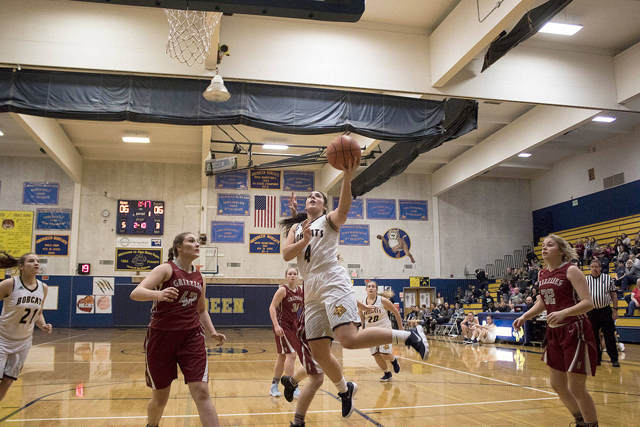 Aberdeen’s Reagan Glanz splits between Hoquiam defenders on her way to the basket on Thursday night. (Brendan Carl Photography)