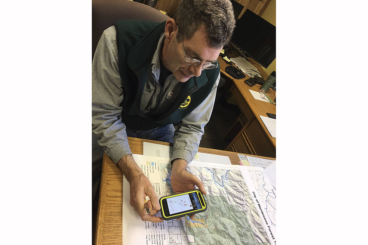 Todd Bennington | Twin Harbors Newspaper Group                                Montesano City Forester Loren Hiner demonstrates the use of a mobile application that will help the public navigate recreational trails more safely.
