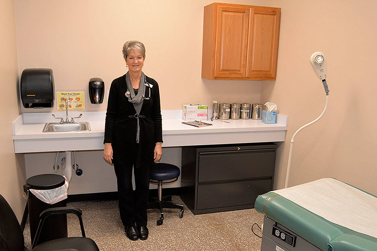 LOUIS KRAUSS | THE DAILY WORLD Nurse practitioner Judy Miller stands in one of two examining rooms at the new walk-in clinic at Swanson’s in Aberdeen. It will serve those with minor ailments such as a cold or the flu.