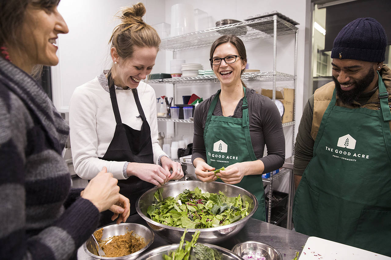 Lelia Navidi | Minneapolis Star Tribune                                Instructor Dr. Kate Shafto, left, helps students make a healthy salad from leftover greens during the Food Matters for Health Professionals class held at Good Acres Kitchen in Falcon Heights, Minnesota.