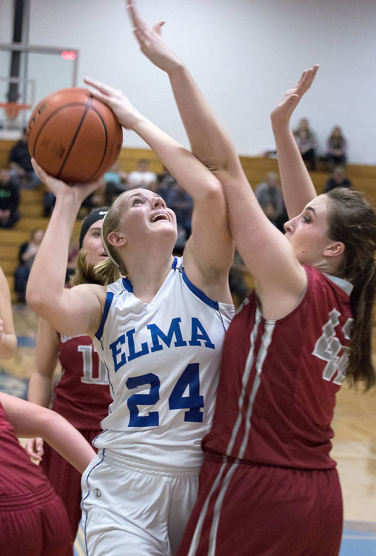 Elma’s Molly Johnston works to try and get around Hoquiam’s Rylee Vonhof on her way to the hoop on Friday. (Brendan Carl Photography)