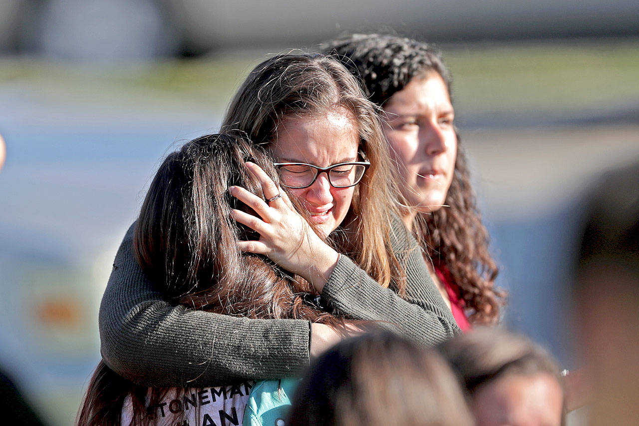Students are released from a lockdown outside of Stoneman Douglas High School in Parkland, Fla., after a shooting on Wednesday, Feb. 14, 2018. (John McCall/Sun Sentinel/TNS)