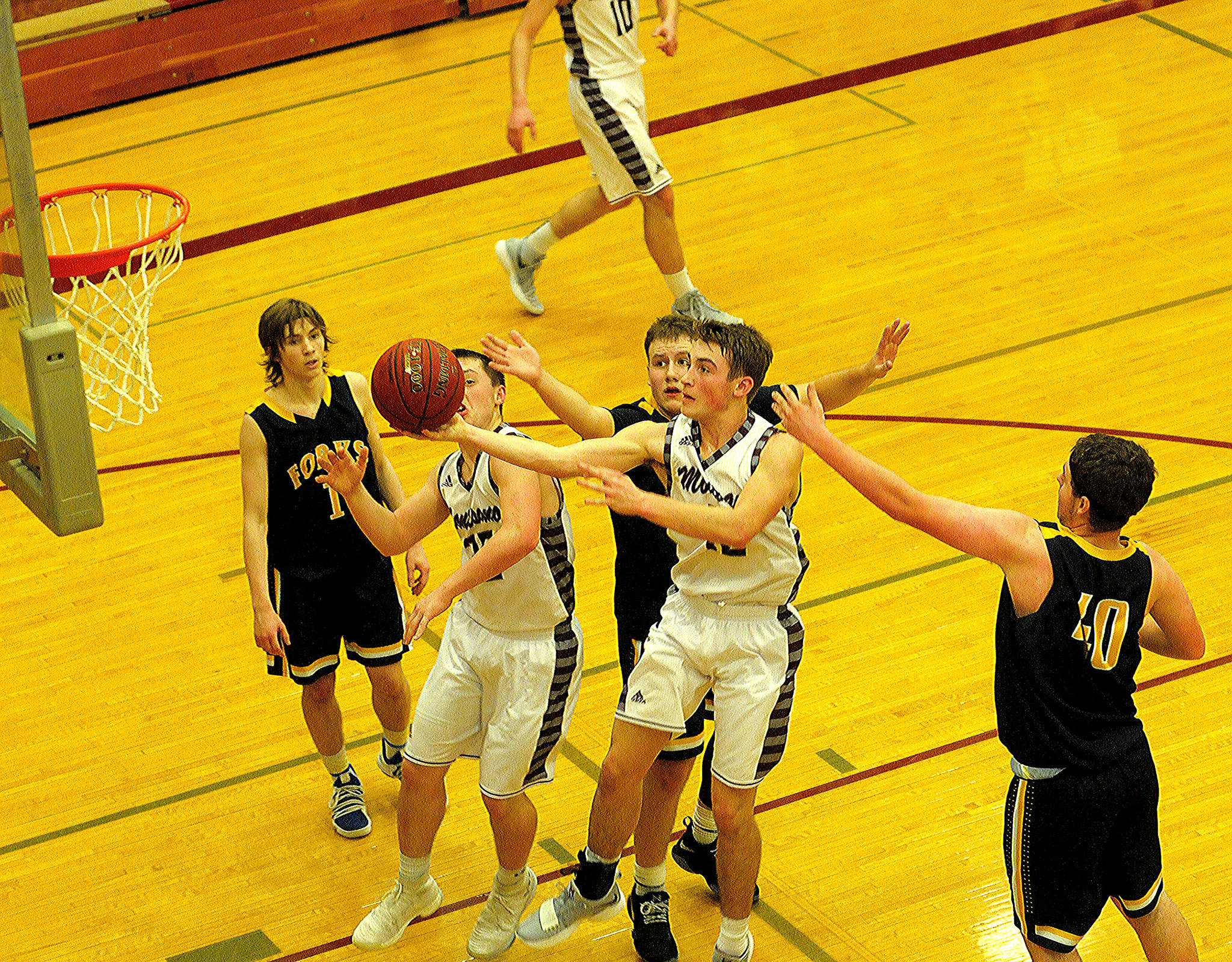 Sam Winter drives to the rim in a district tournament game against Forks.
