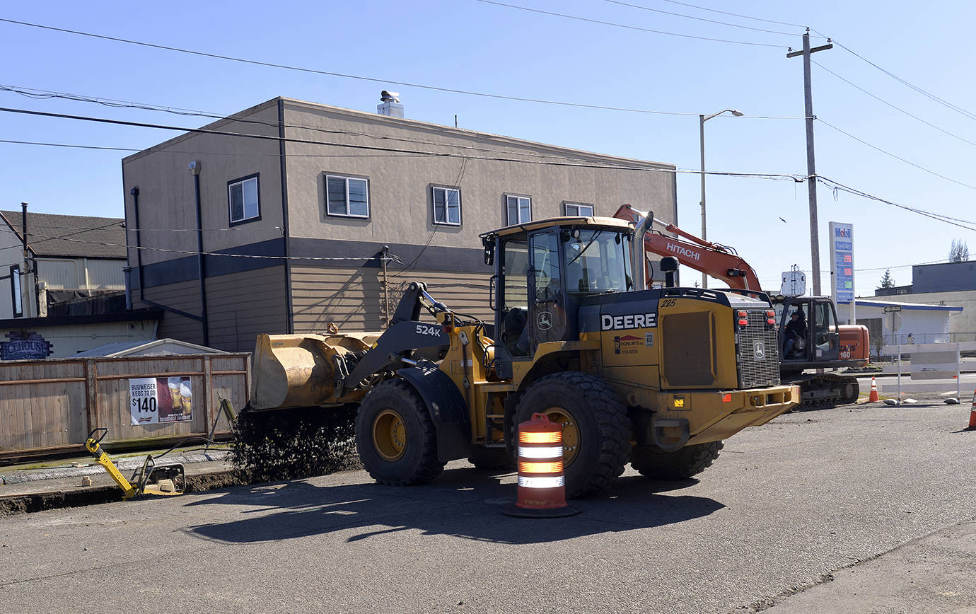 DAN HAMMOCK | THE DAILY WORLD                                Gravel is dumped into a trench carved into Ontario Street just north of the Simpson Avenue intersection. Crews were laying a bed for the larger stormwater drainage pipes that are hoped to alleviate chronic flooding at the intersection.