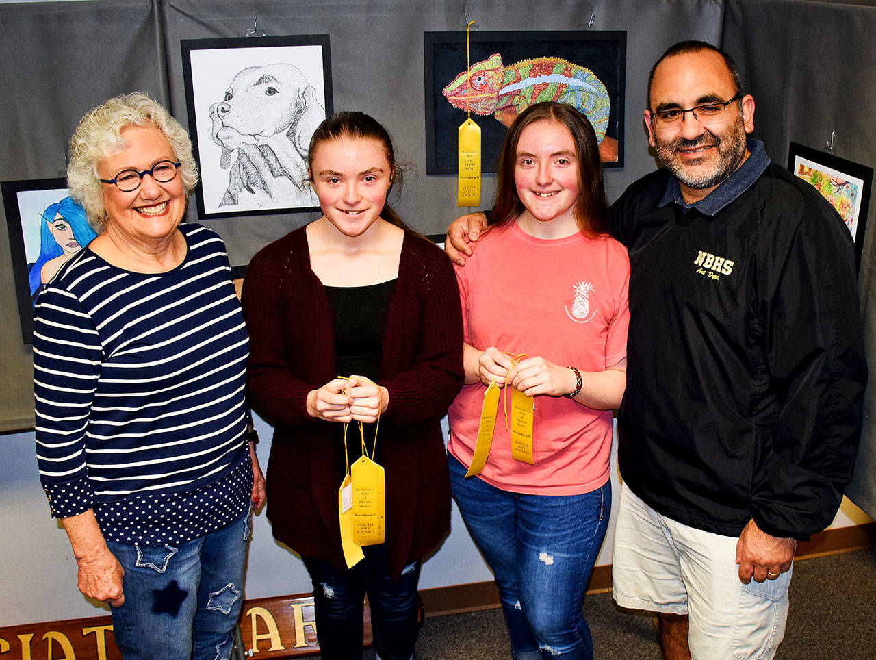 Photo by Scott B. Johnston                                North Beach High School sophomores Mia and Abby Loudenback are flanked by AAOS Youth Art Show Chairwoman Kathy Harris and art teacher Richard Villar at the March 30 show. The sisters received six awards between them.