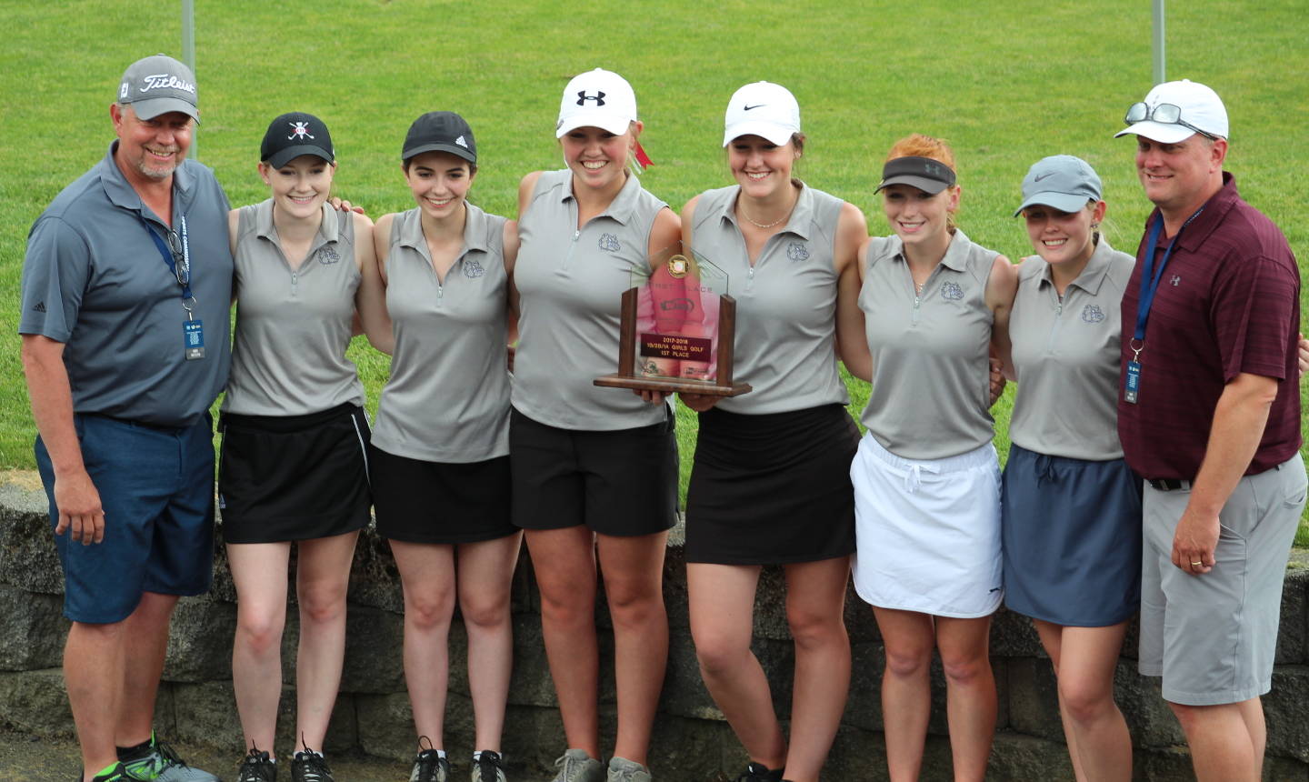 Photo by Angela Denholm The Montesano golf team (from left) head coach Doug Galloway, Lauren Denholm, Morgan Malizia, Macey Wecker, McKenna Miller, Glory Grubb, Mylaina Parker and coach Jon Parker pose with their state championship trophy after winning the 1A/2B/1B State Tournament on Wednesday.