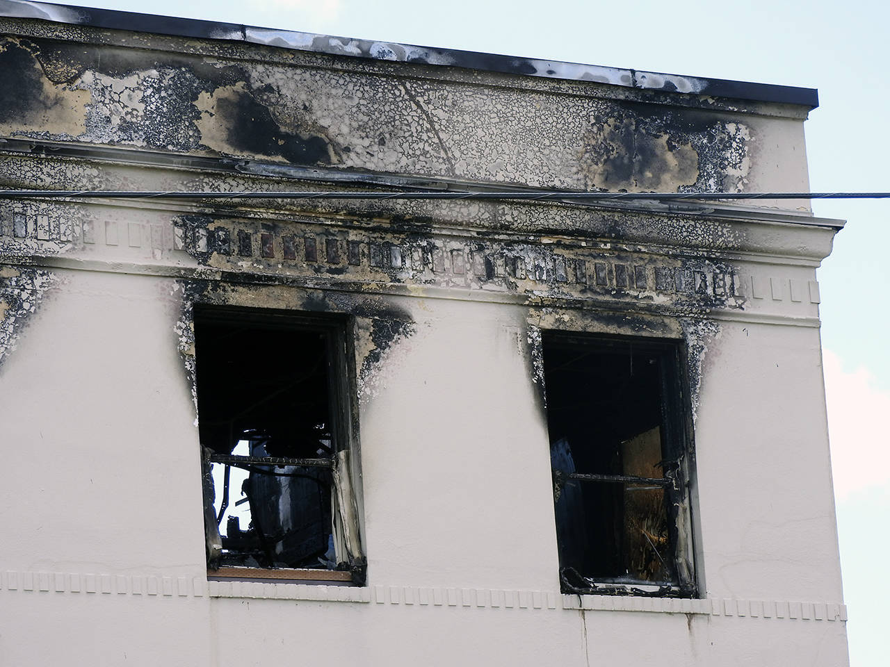 (Kat Bryant | The Daily World) Flames shot out of these upper windows at the northeast corner of the building.