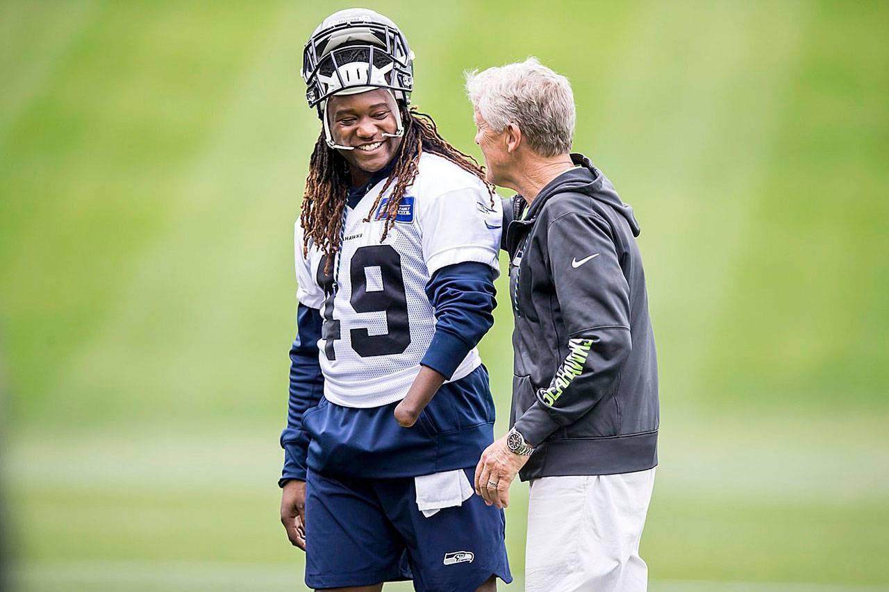 Seahawks linebacker Shaquem Griffin gets a pat on the back from head coach Pete Carroll after Seattle Seahawks minicamp at the Virginia Mason Athletic Center in Renton on Thursday. (Bettina Hansen/The Seattle Times)