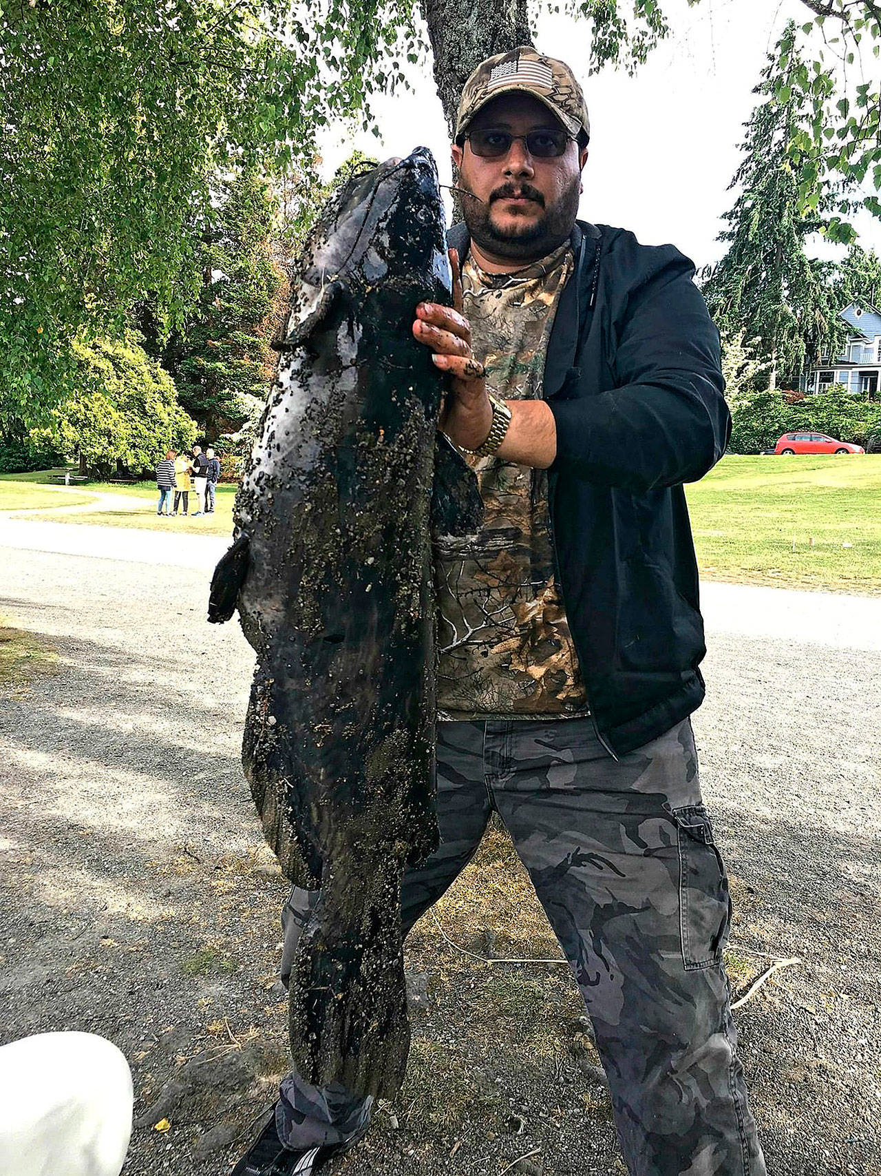 Ahmed Majeed shows off his catch of a huge catfish on Saturday at Green Lake. (Photo courtesy of Ahmed Majeed)