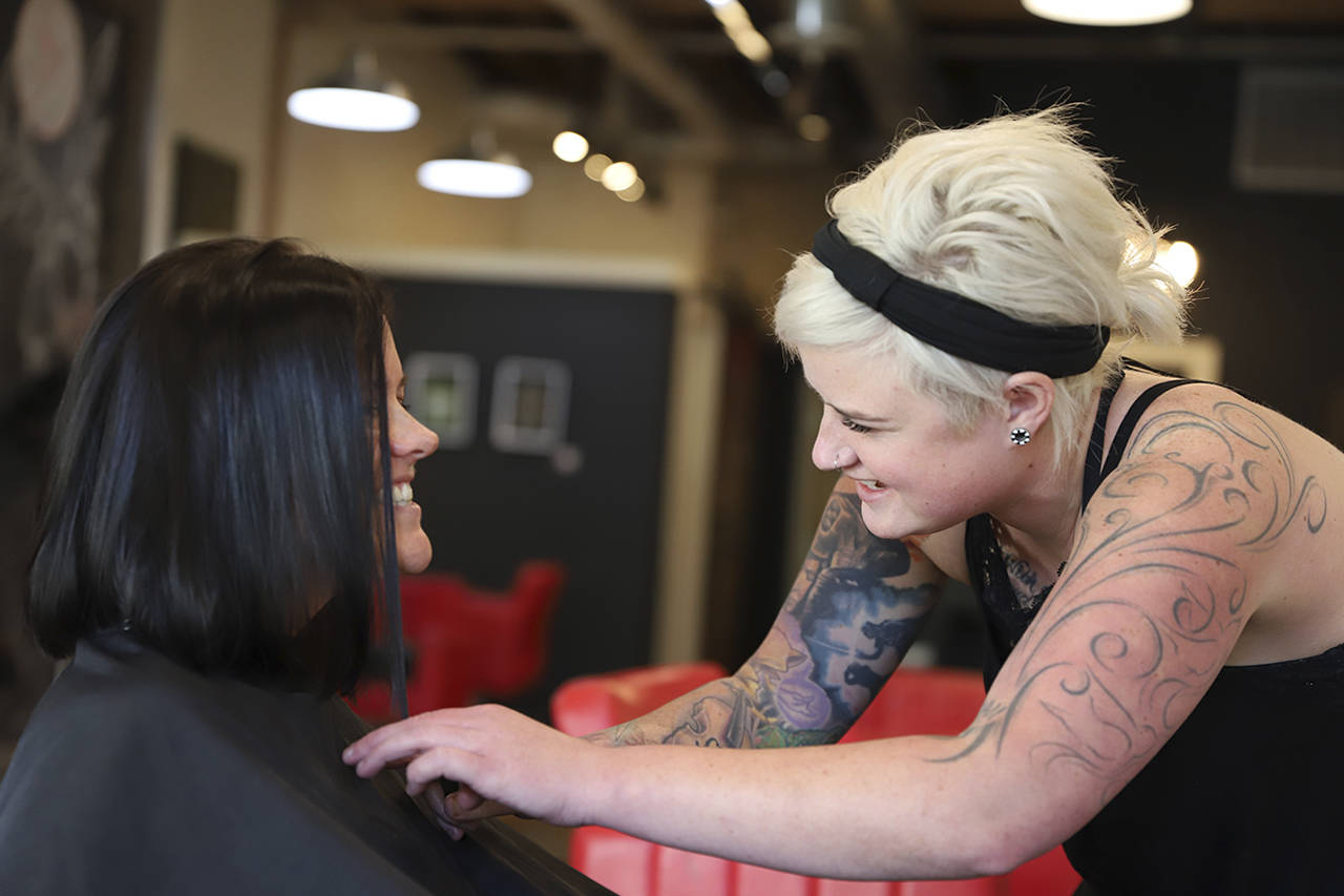 (Justin Silvis/Minneapolis Star Tribune) As part of the Steller Kindness Project, Katie Steller gives Katie Naughton a complimentary haircut and style.