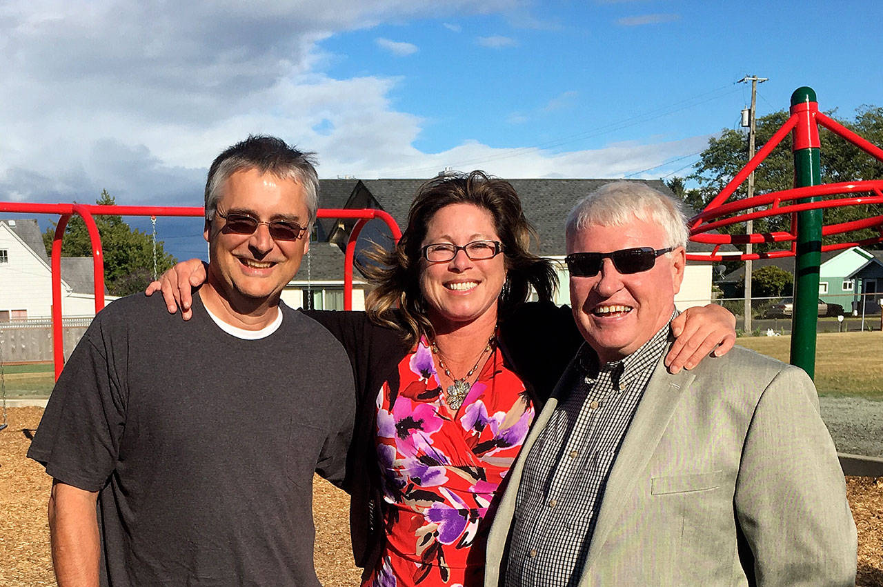 Louis Krauss | The Daily World                                Former longtime Aberdeen Parks Director Wes Peterson, right, stands with current director Stacie Barnum and Karl Harris, who was the director after Peterson. A dedication was held for the renovated Peterson Playfield on Tuesday.