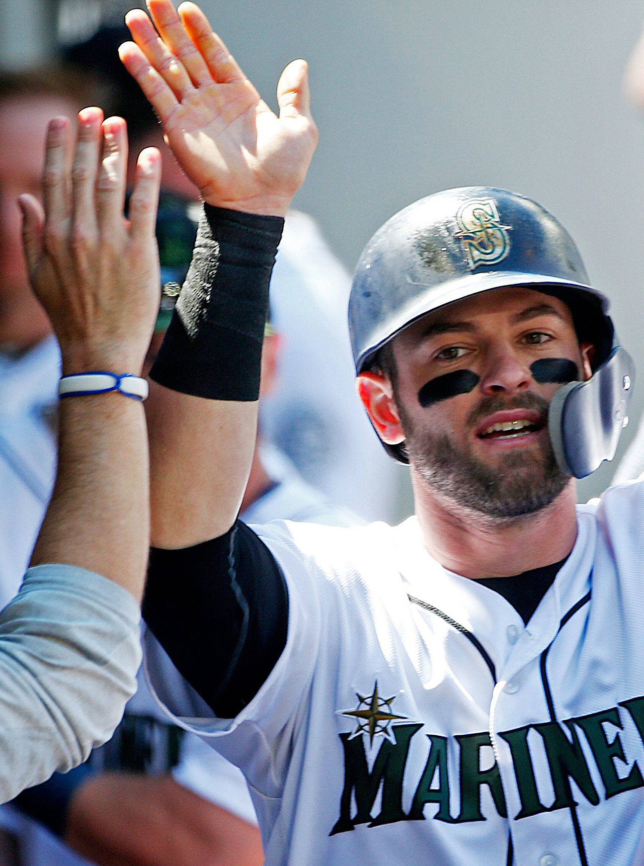 Mariners right fielder Mitch Haniger celebrates in the dugout after scoring the go-ahead run off a Kyle Seager single in the sixth inning against Texas, Monday, May 28, 2018 at Safeco Field in Seattle. The Mariners won, 2-1. (Ken Lambert/Seattle Times/TNS)