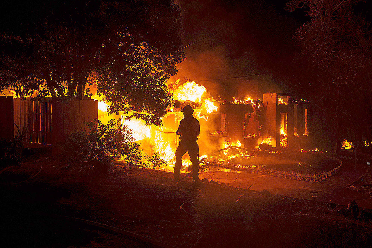 At least 2 dead, scores of homes lost as fire sweeps into Redding, Calif.