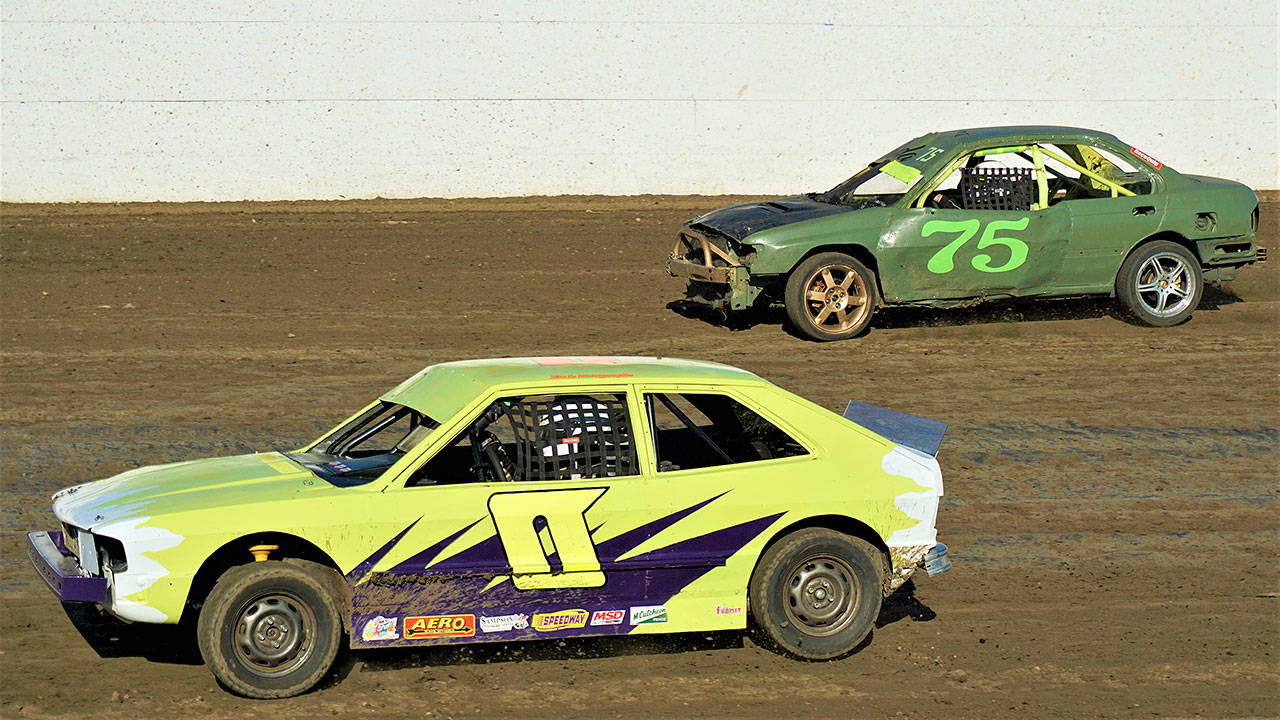 Zach Dalrymple (o) leads Chad Norton during the Outlaw Tuner feature race on Saturday at Grays Harbor Raceway in Elma. Norton went on to win the race. (Photo by AR Racing Videos)