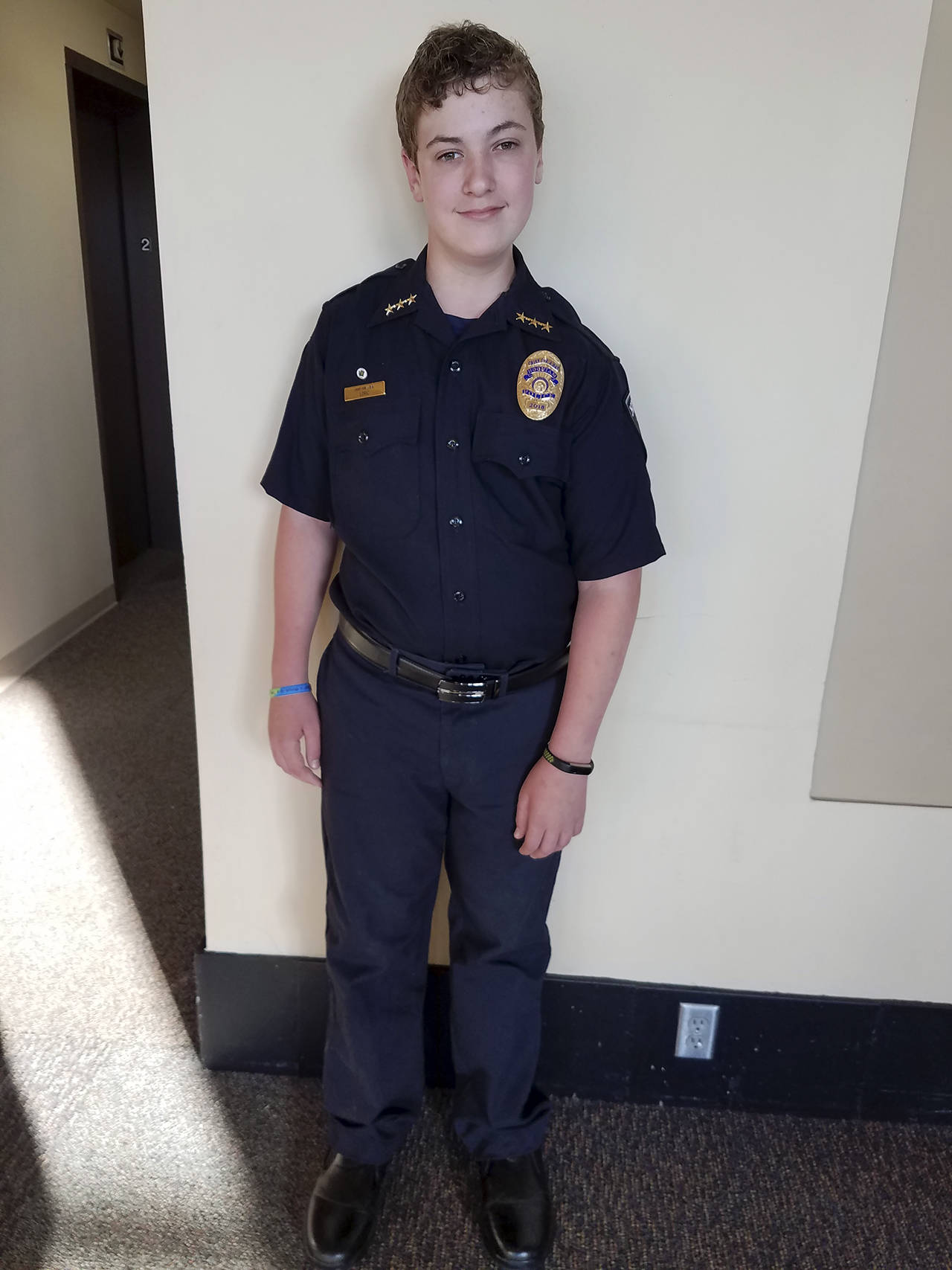 Courtesy photo                                Loric Colgrove proudly wears his uniform and badge as Hoquiam’s Chief for a Day.