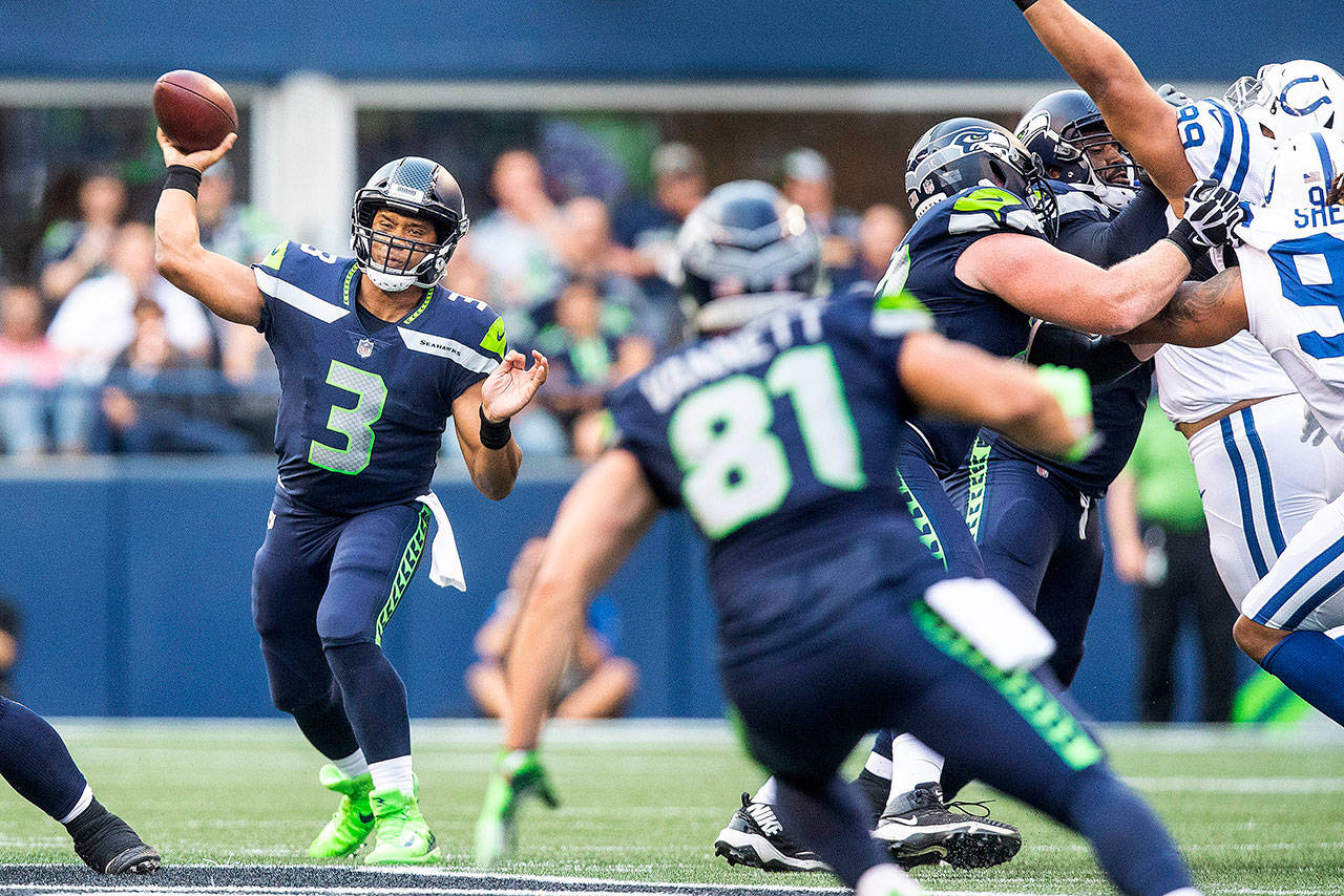 Seattle Seahawks quarterback Russell Wilson (3) spots up intended receiver Nick Vannett (81), who slips trying to make the cut, and is unable to pull down the catch in the first quarter against the Indianapolis Colts in preseason action at CenturyLink Field in Seattle on Thursday, Aug. 9, 2018. (Dean Rutz/Seattle Times/TNS)