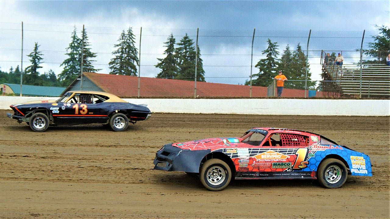 Don Briggs Sr. (left) races with Cory Sweatman during the Street Stocks Iron Man Challenge on Saturday at Grays Harbor Raceway. Sweatman came from the third spot to earn the checkered flag. (Photo by AR Racing Videos)