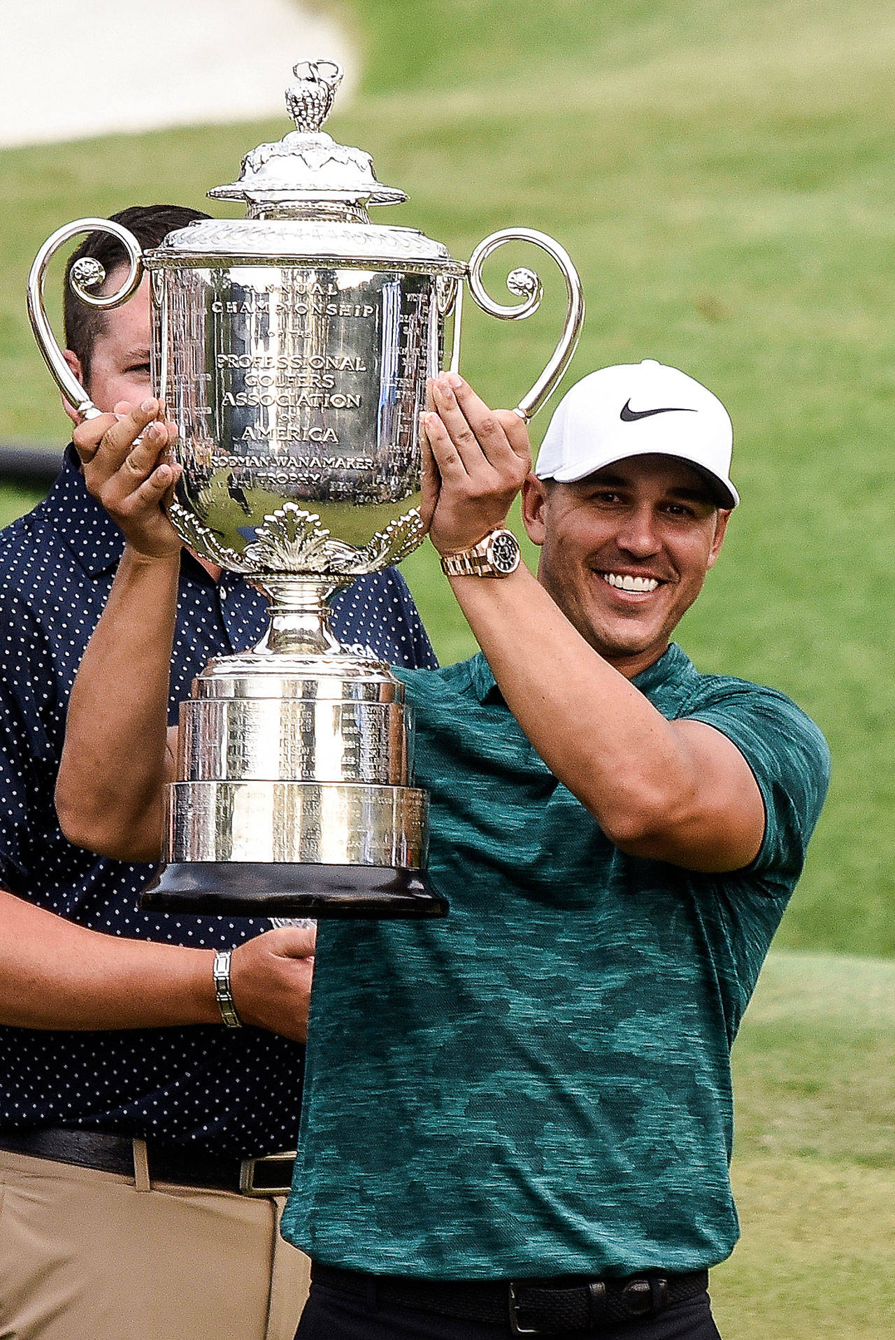 Brooks Koepka raises the Wanamaker Trophy after winning the PGA Championship on Sunday, Aug. 12, 2018 at Bellerive Country Club in St. Louis, Mo. (Richard Ulreich/Zuma Press/TNS)