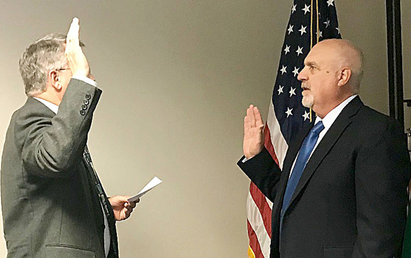 PHOTO COURTESY PORT OF GRAYS HARBOR Phil Papac of Montesano (right) is sworn in as Port of Grays Harbor District 1 commissioner Tuesday at the Satsop Business Park.