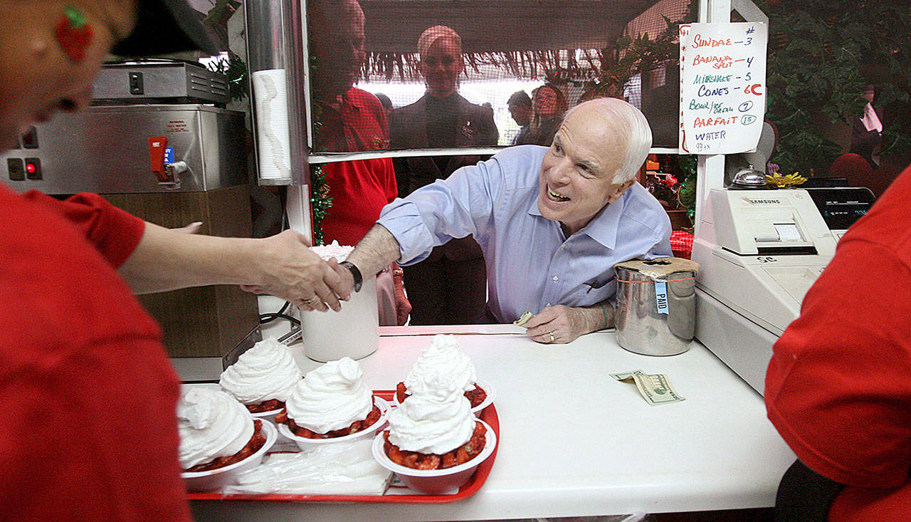 GOP presidential candidate Sen. John McCain leans through a window at the order counter at Parkesdale Farm Market roadside stand, for some strawberry shortcake, in Plant City, Fla., in October of 2008, during a campaign stop on his bus tour across Florida. (Joe Burbank/Orlando Sentinel)