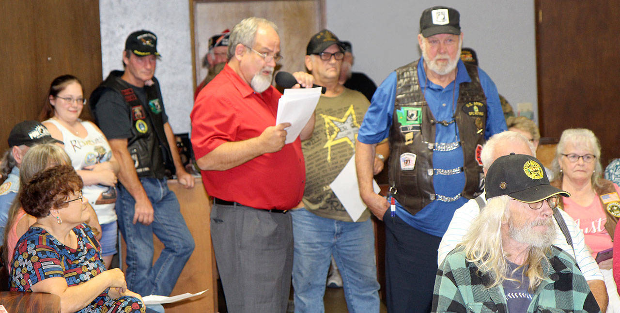 Elma Mayor Jim Sorensen, center holding papers and microphone, calls out the names of Vietnam War veterans or their family members during a ceremony Wednesday, Aug. 22, 2018, at the Fraternal Order of Eagles hall in Elma. Photo by Michael Lang, The Vidette