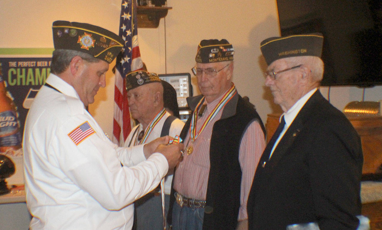 Michael Lang | Twin Harbors Newspaper Group                                Above, Commander Kyle Winkle, from left, of the Veterans of Foreign Wars Post 2455 in Montesano, presents Ambassador for Peace medals to Korean War veterans Herb Beck of Montesano and Maurice Fox and Lloyd Jorgensen, both of Aberdeen, during a ceremony Aug. 21 at the VFW hall in Montesano. At left, Grant Edwards receives recognition from Winkle for his 60-year membership at the VFW. Edwards, 99, is believed to be the oldest veteran in the county.