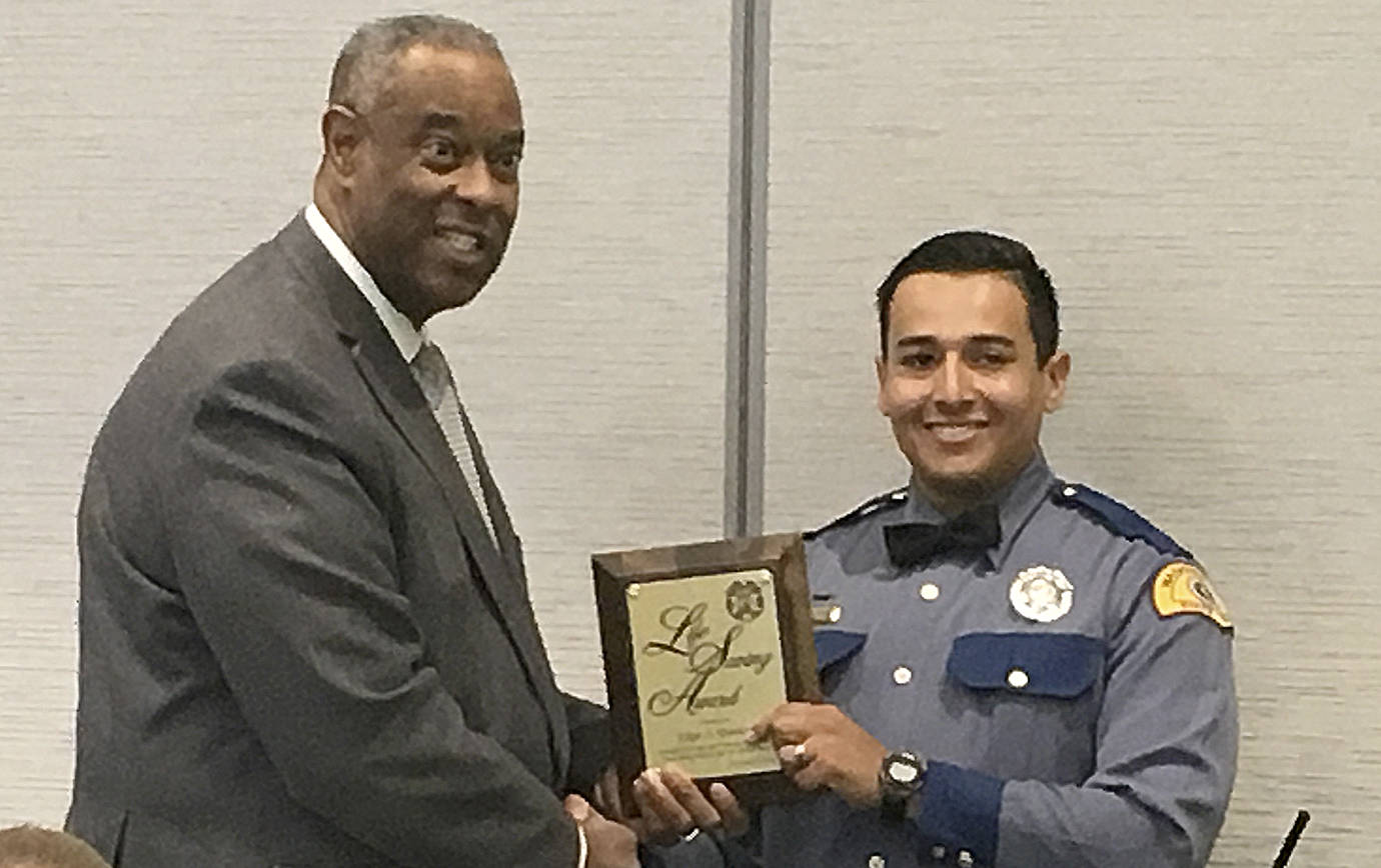 COURTESY PHOTO                                Washington State Patrol Trooper Edgar Quintero of Naselle is awarded for his life-saving efforts after a reported shooting and stabbing incident in Ilwaco in April. Handing him the Life Saving Award is State Patrol chief John R. Batiste.