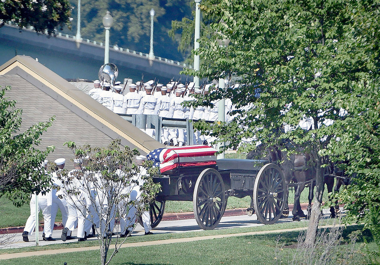 A horse-drawn caisson carries the casket of Sen. John McCain to the Naval Academy Cemetery for burial on Sunday in Annapolis, Md. (Kenneth K. Lam/Baltimore Sun)