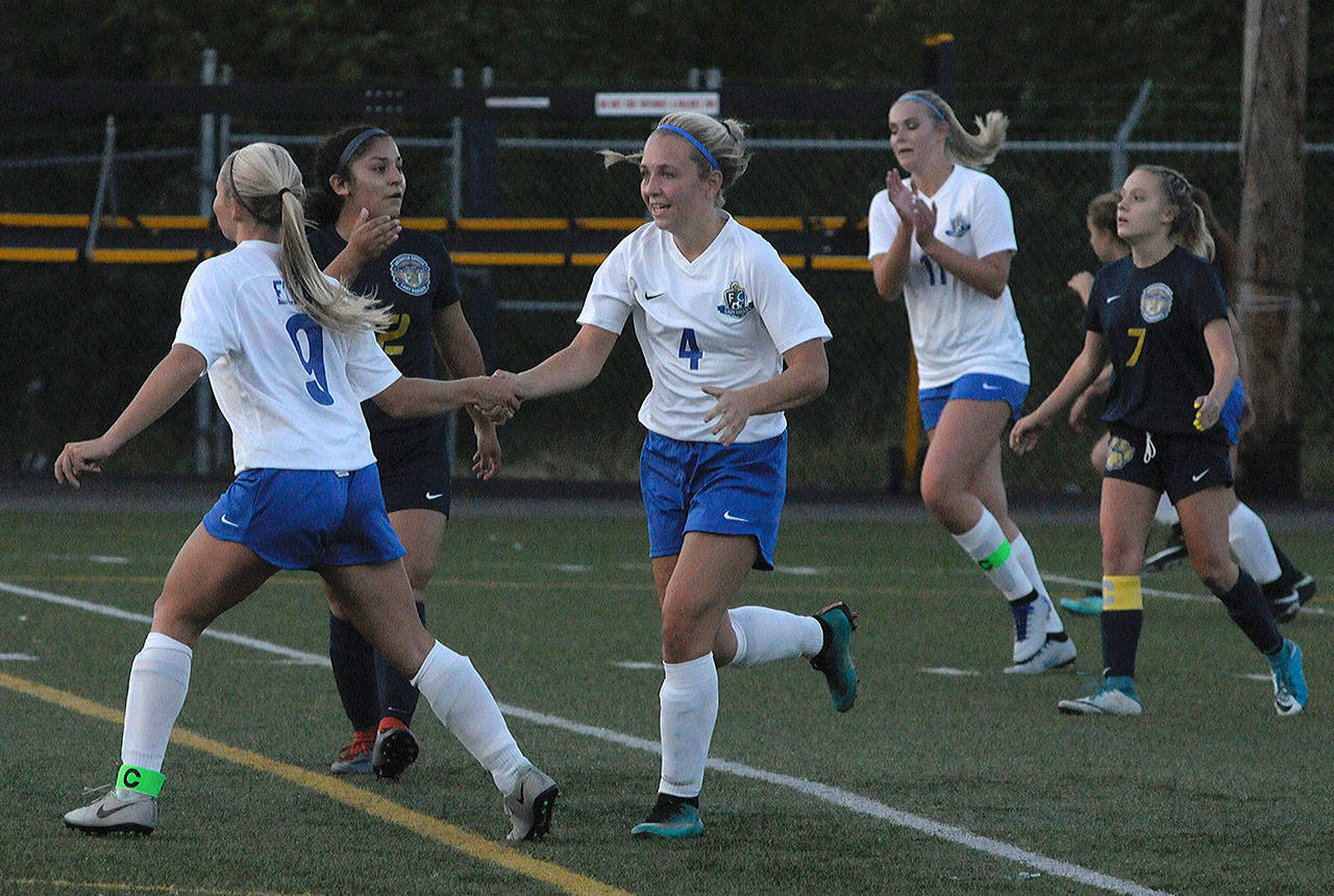 Elma’s Kassedy Olson, left, celebrates her goal with Kayli Johnson in the 21st minute of a game against Aberdeen at Stewart field on Tuesday. (Hasani Grayson | The Daily World)