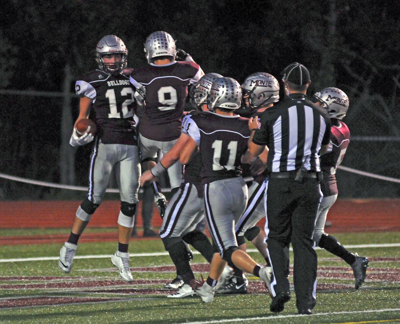 Montesano receiver Sam Winter (12) celebrates with his teammates after catching a 32-yard touchdown pass in the second quarter of the Bulldogs’ 51-6 victory over Shelton on Friday in Montesano. (Ryan Sparks | The Daily World)