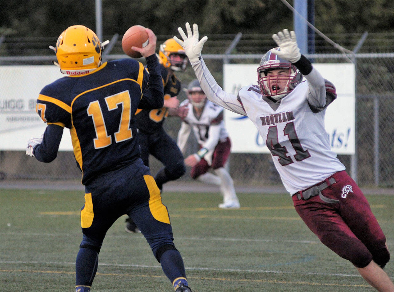 Aberdeen’s Ben Dublanko, left, tries to avoid pressure from Hoquiam’s Ben Estes during the first quarter of the 113th iteration of the Myrtle Street Rivalry on Friday in Aberdeen. (Hasani Grayson | The Daily World)