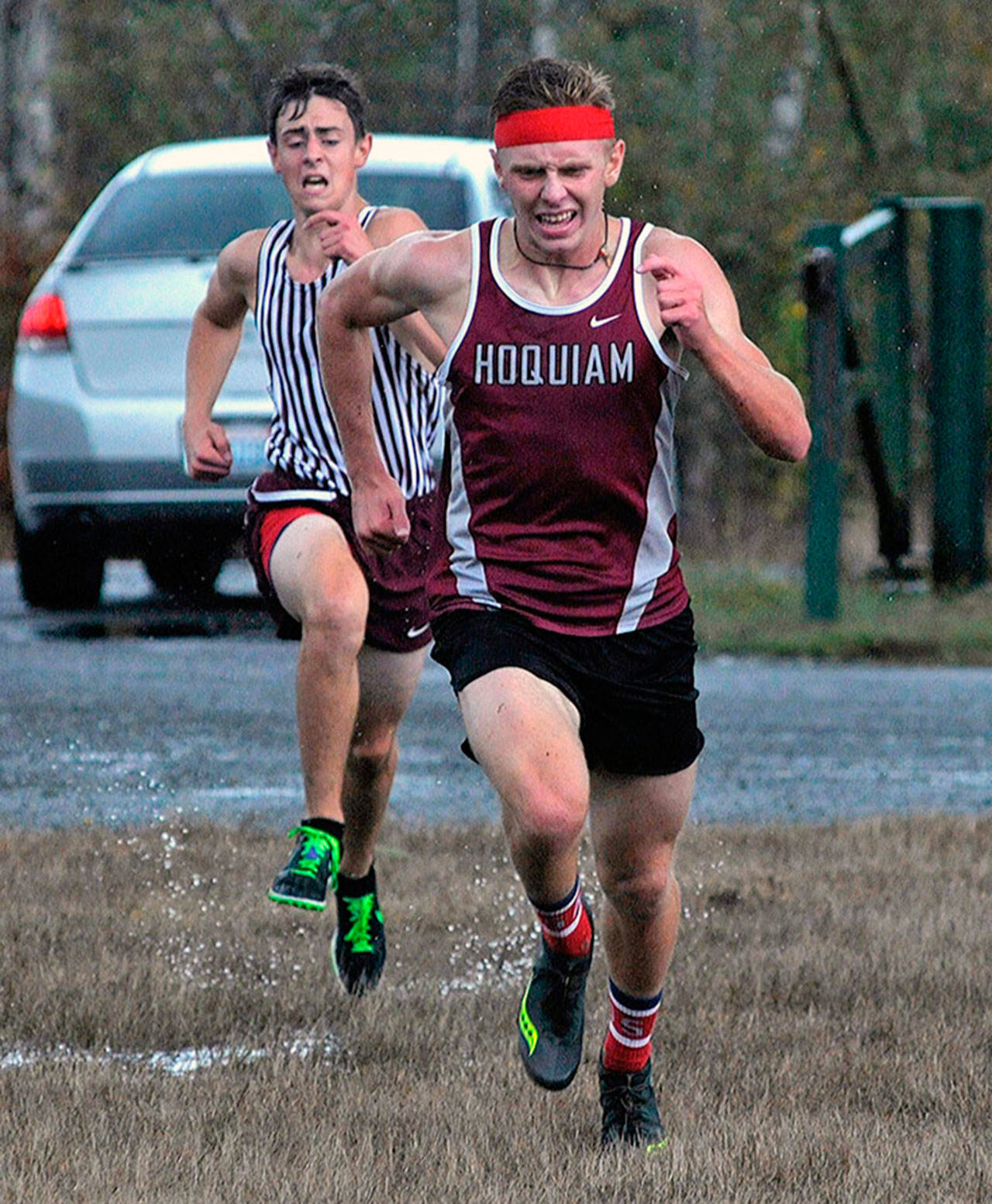 Hoquiam’s Alex Petersen, right, pulls ahead of Montesano’s Martin Shuck at the Elma cross country meet on Thursday. Petersen took second while Shuck finished third. (Hasani Grayson | The Daily World)