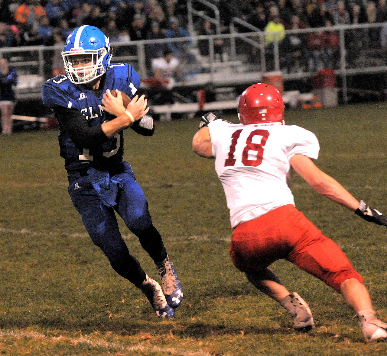 Elma’s Cody Vollan, left, jukes Castle Rock’s Peyton Watts on a touchdown run in the first quarter of the Eagles’ 47-21 win on Friday in Elma.(Hasani Grayson | The Daily World)