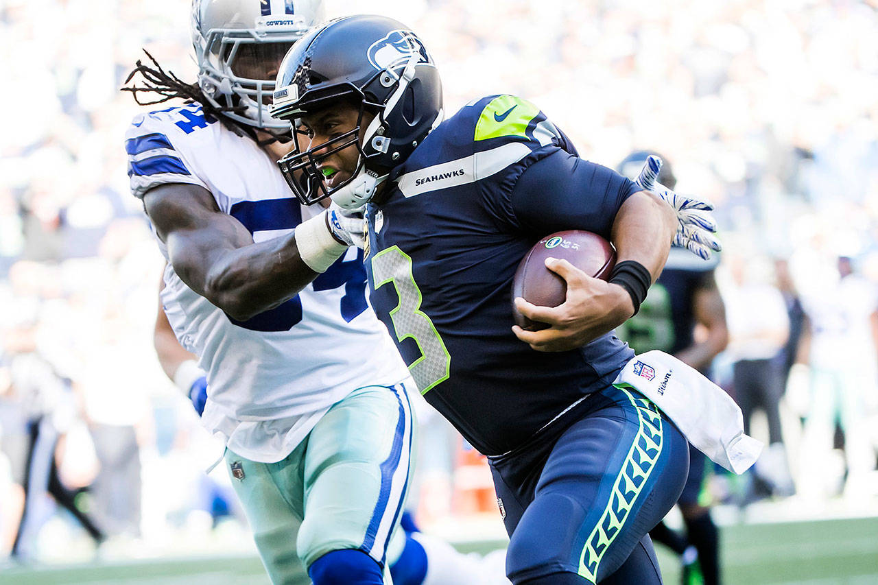 Dallas Cowboys linebacker Jaylon Smith runs Seattle Seahawks quarterback Russell Wilson out of bounds on a 1-yard scramble in the fourth quarter on Sunday, Sept. 23, 2018 at CenturyLink Field in Seattle, Wash. (Bettina Hansen/Seattle Times/TNS)
