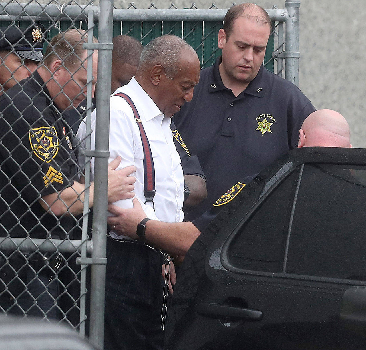 Entertainer Bill Cosby is escorted out in shackles from the Montgomery County courthouse in Norristown, Penn., on Tuesday. Cosby was sentenced to three to 10 years in prison. (David Maialetti/Philadelphia Inquirer)