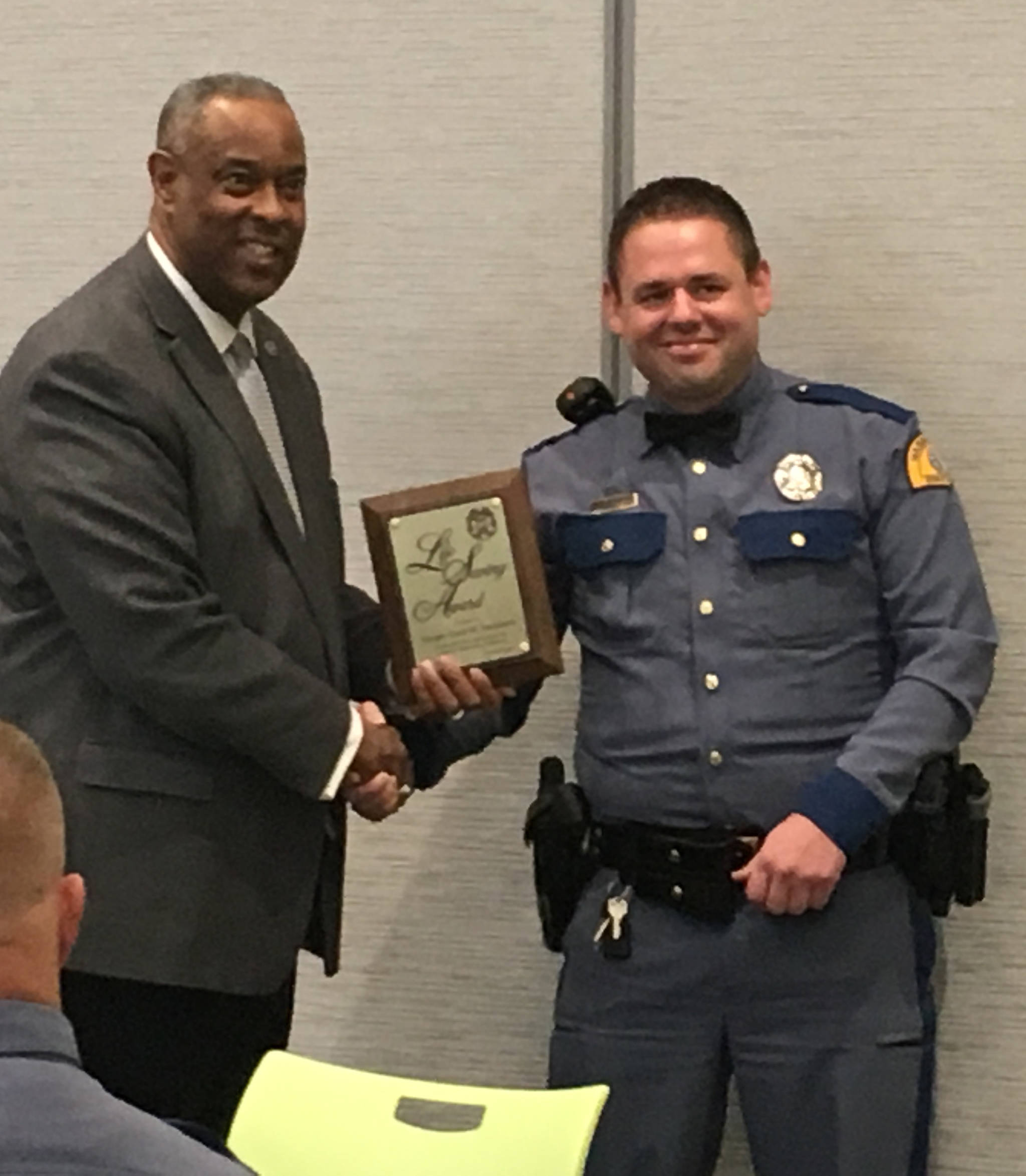 Washington State Patrol Trooper David Franzmann of Hoquiam, right, receives a life-saving award from WSP Chief John R. Batiste.