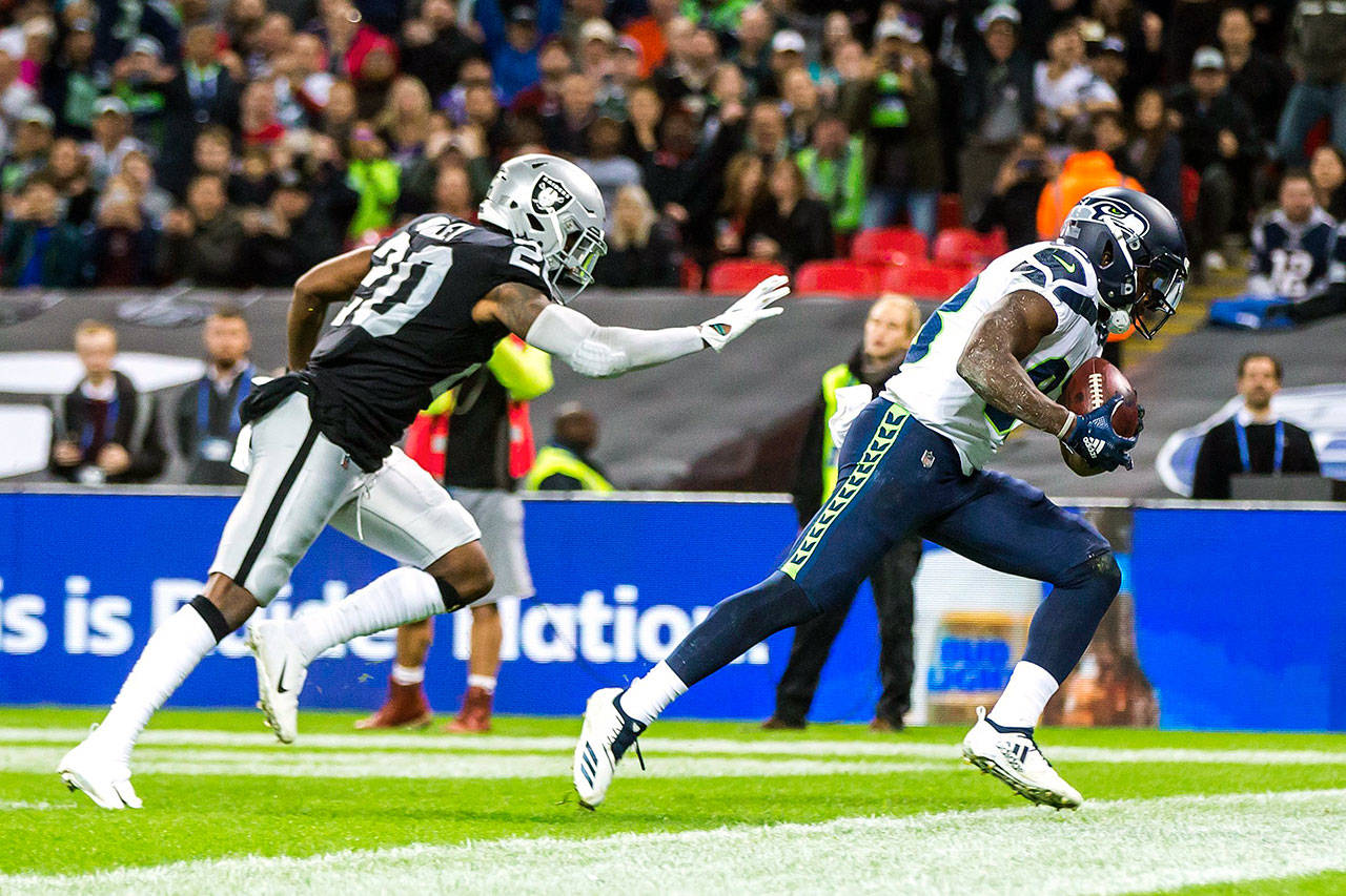 Seattle Seahawks wide receiver David Moore makes a touchdown reception against Oakland Raiders cornerback Daryl Worley on Sunday, Oct. 14, 2018 at Wembley Stadium in London, England. (Bettina Hansen/Seattle Times/TNS)