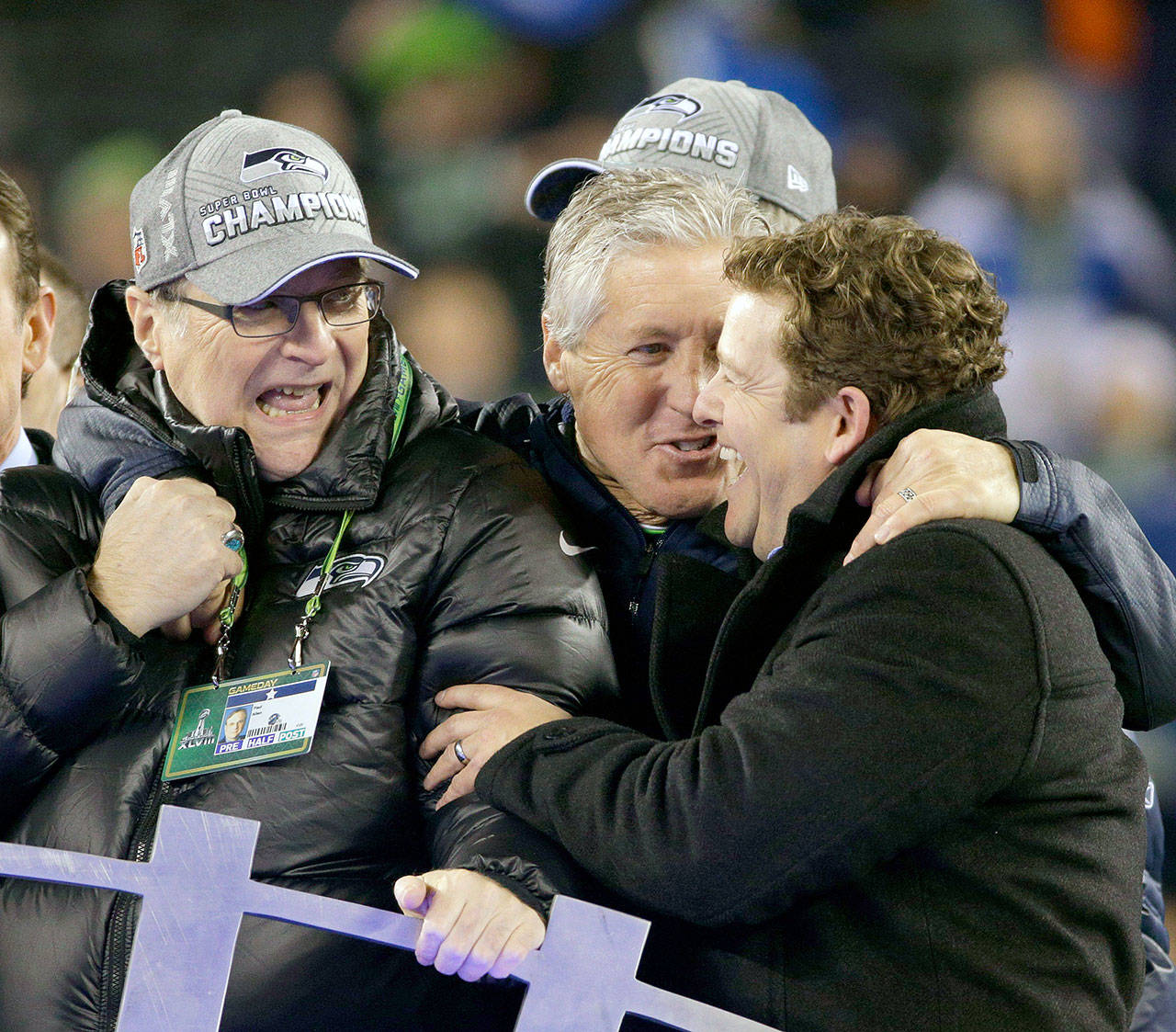 From left, Seattle Seahawks team owner Paul Allen, head coach Pete Carroll and general manager John Schneider celebrate on the trophy stand after a 43-8 victory against the Denver Broncos in Super Bowl XLVIII at MetLife Stadium in East Rutherford, N.J., on Sunday, Feb. 2, 2014. (Mark Cornelison/Lexington Herald-Leader/MCT)