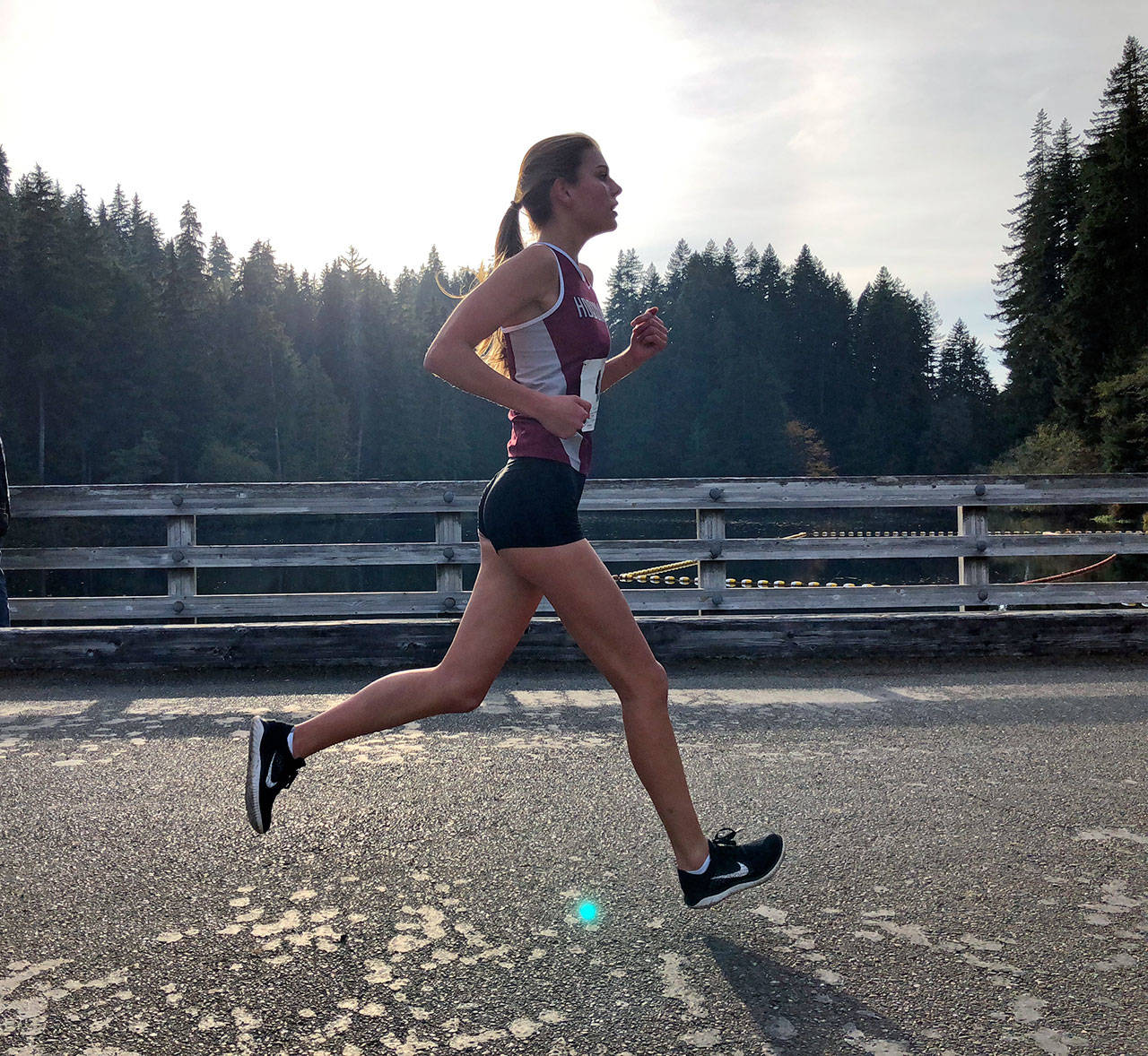Hoquiam’s Valerie Roloff runs along the Lake Sylvia Bridge during the 1A Evergreen Championship meet on on Thursday in Montesano. (Photo by Carly Giles)