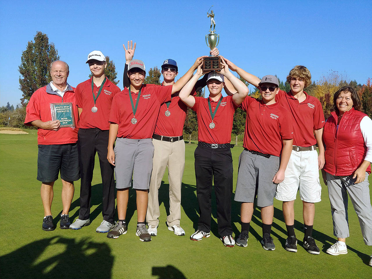 The Hoquiam boys golf team hoists the 1A District championship trophy on Friday in Tumwater. Pictured (left to right) are: Grizzlies head coach Larry DuBlanko, Tayte Witherbee, Michael Jump, Brayden Dayton, Josh Burgher, Noah Sudderth, Tyler Sundstrom and Patty Sundstrom. (Submitted photo)