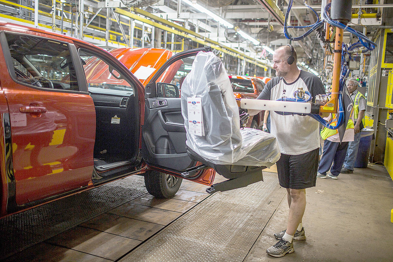 A Ford employee installs a seat on a 2019 Ford Ranger at the Michigan Assembly Plant. (Ford Motor Co.)